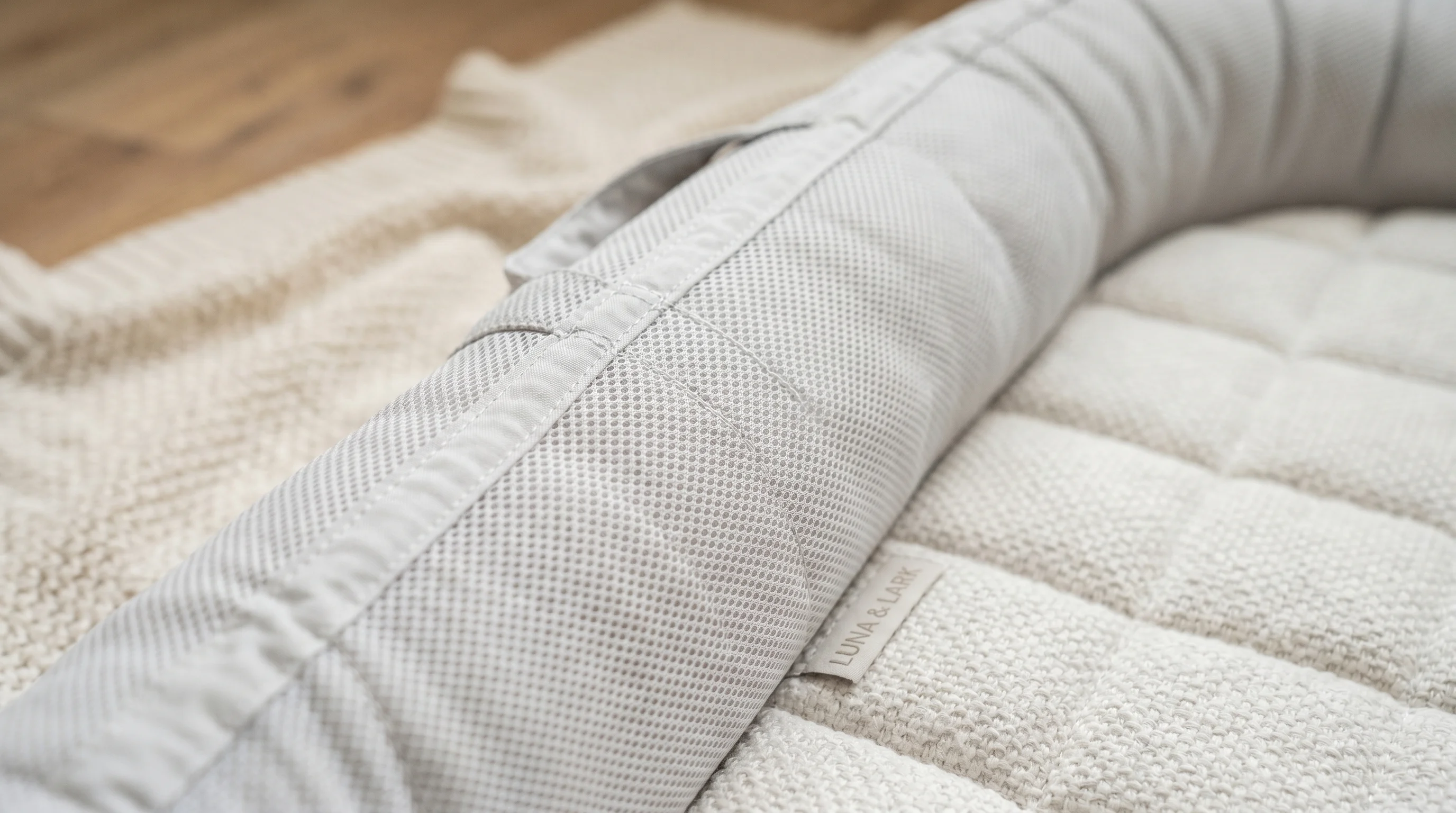 Baby nest breathable mesh sides and firm mattress base — safe construction detail