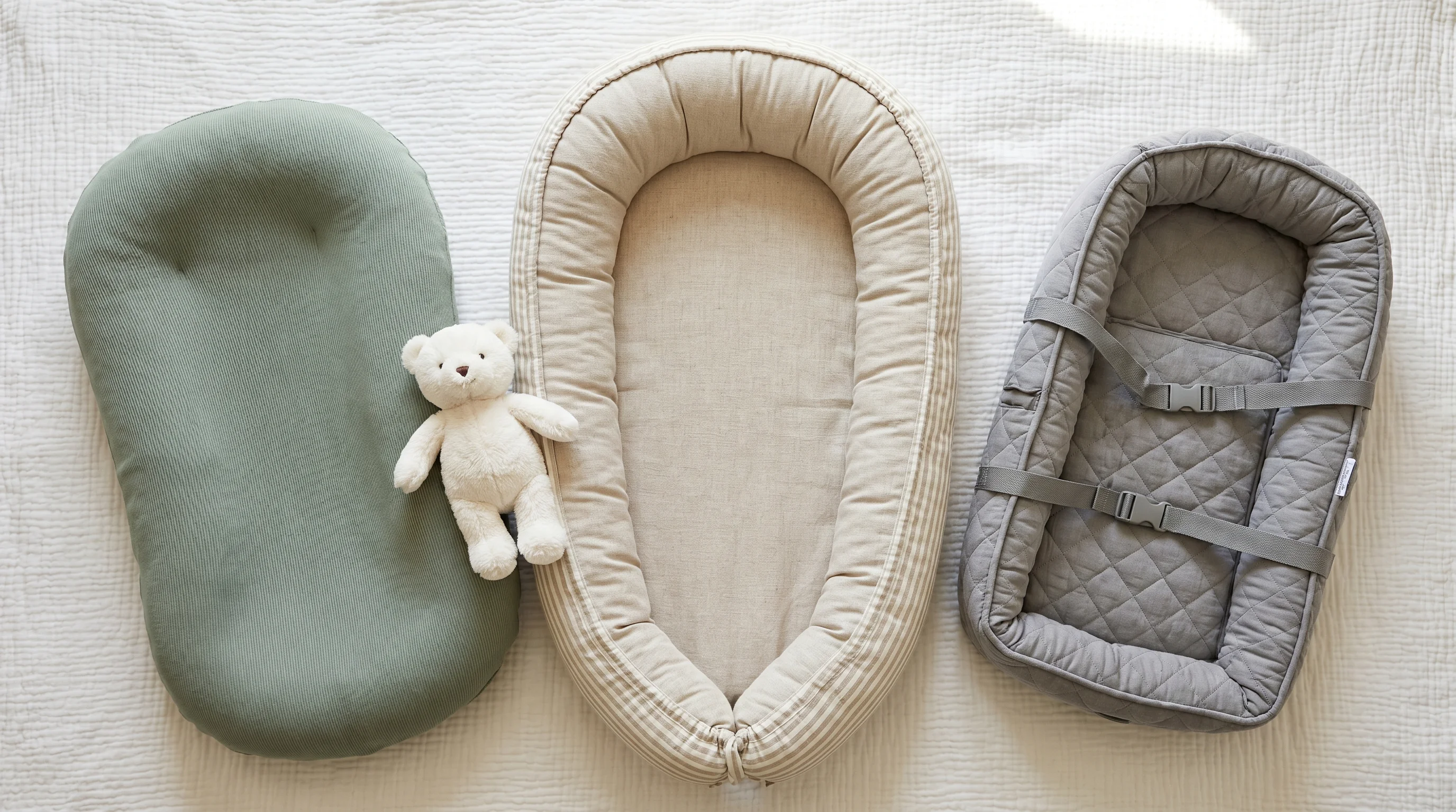 Different types of baby nest UK — stretchy pod, structured oval nest and travel version