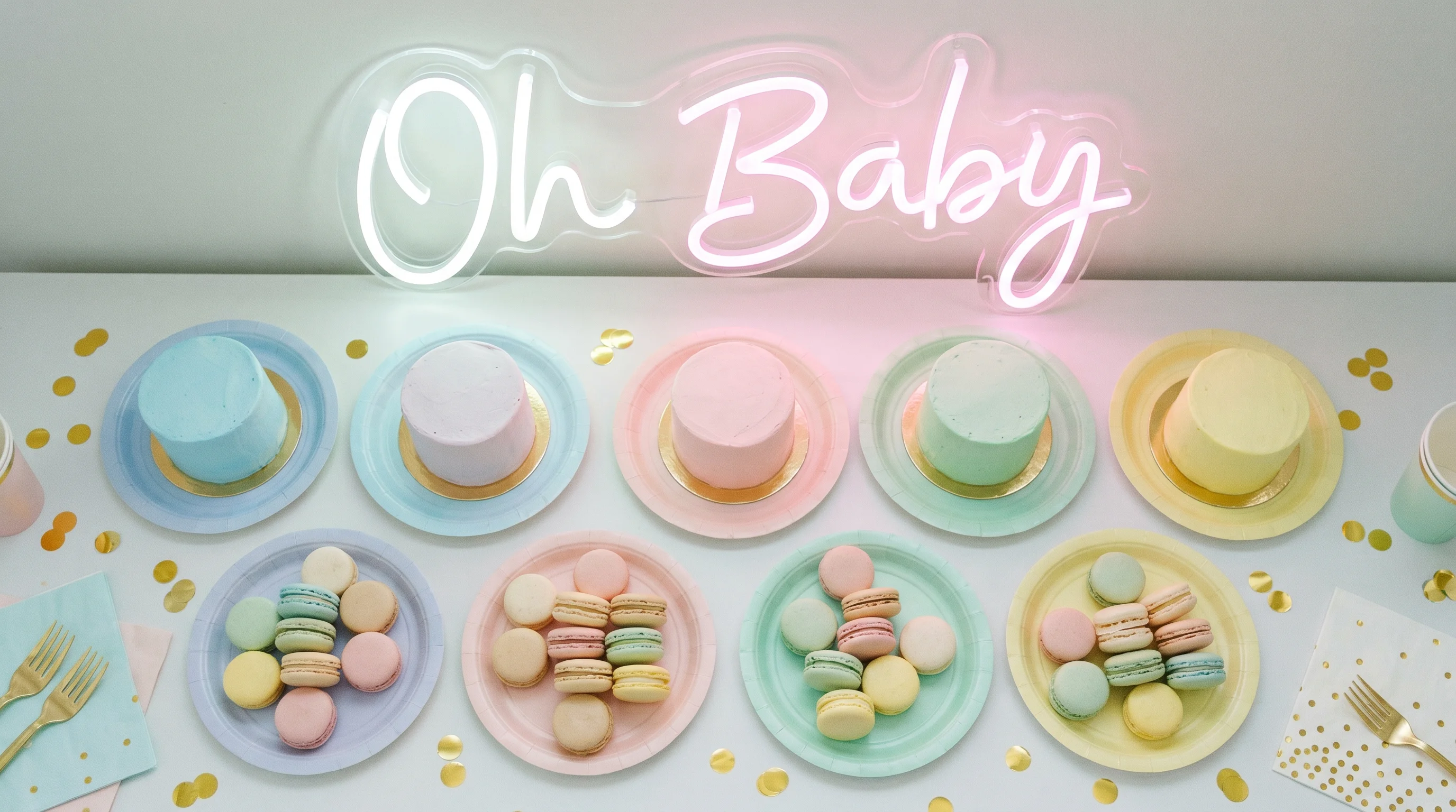 Baby shower dessert table UK — flower centrepiece, cake and styled tableware